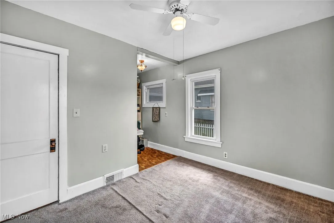 Unfurnished bedroom featuring carpet and ceiling fan