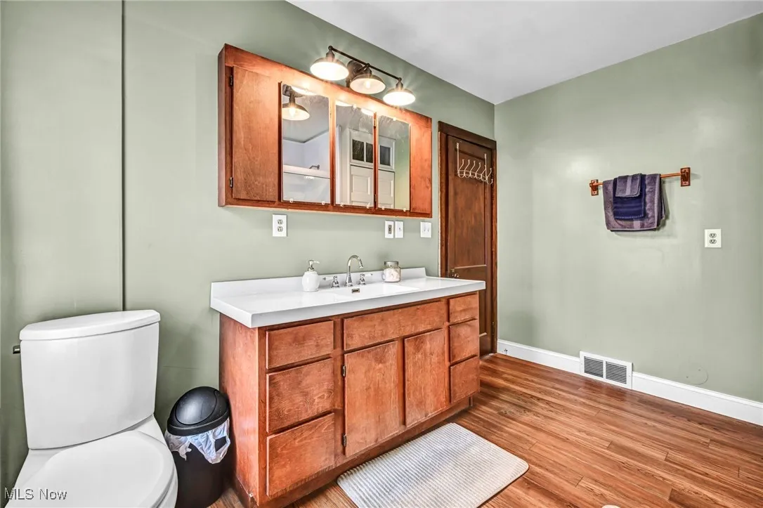 Bathroom with vanity and wood finished floors