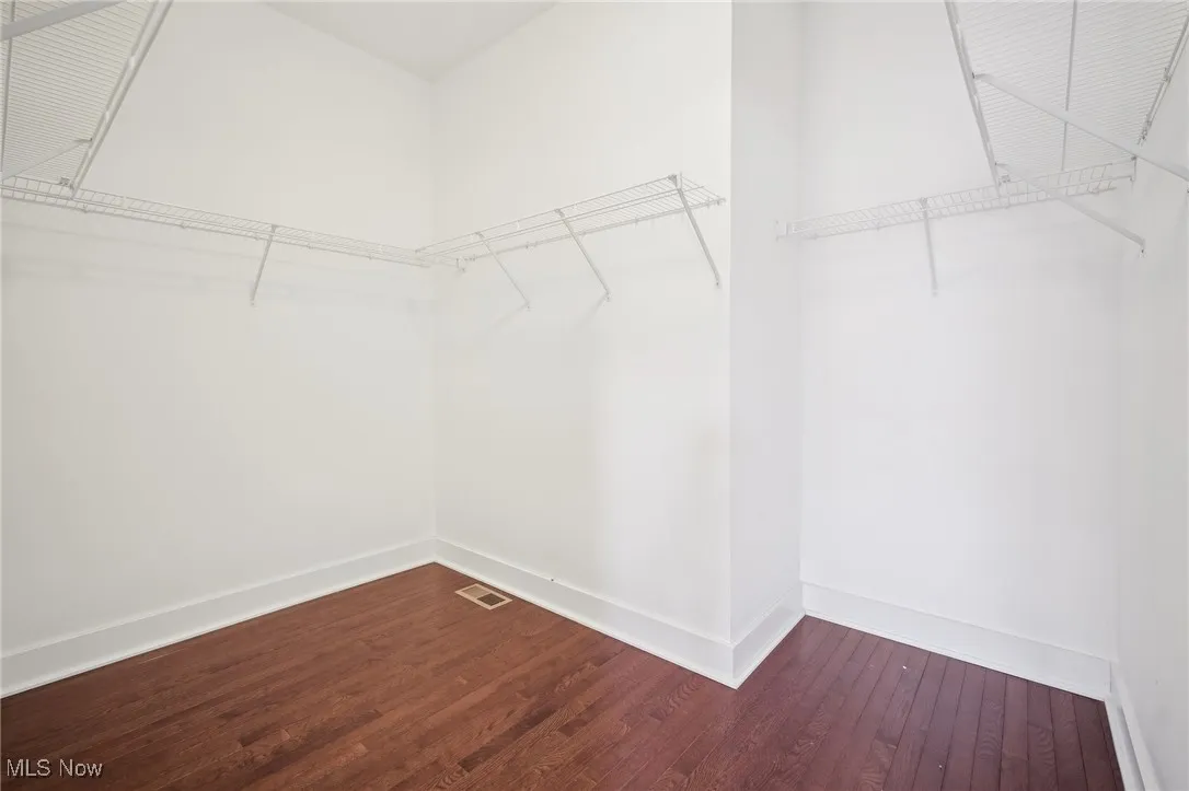 Walk in closet with wood finished floors