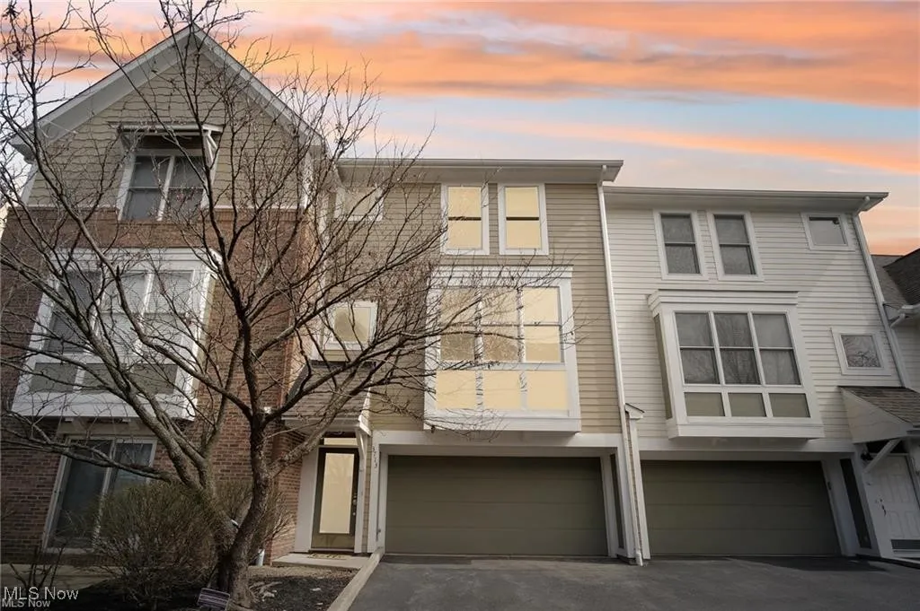 View of front of house with a garage and driveway