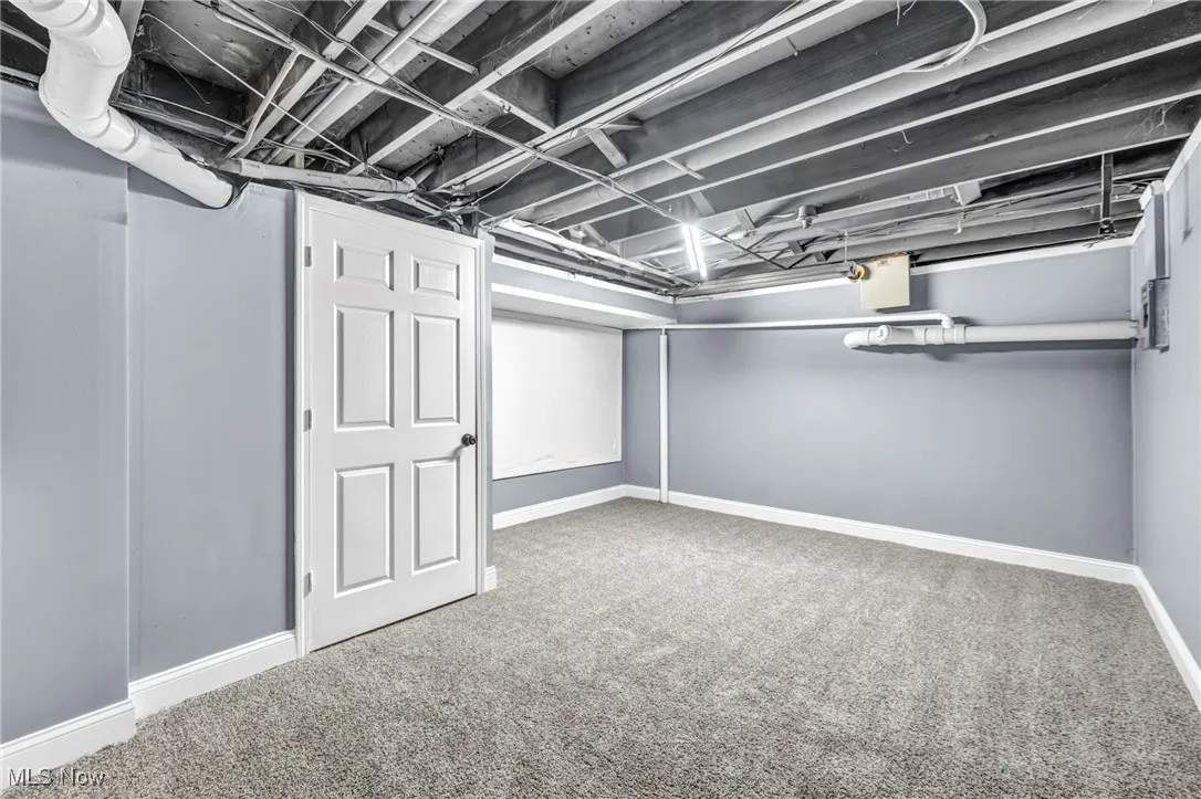 Finished below grade area featuring carpet floors and baseboards