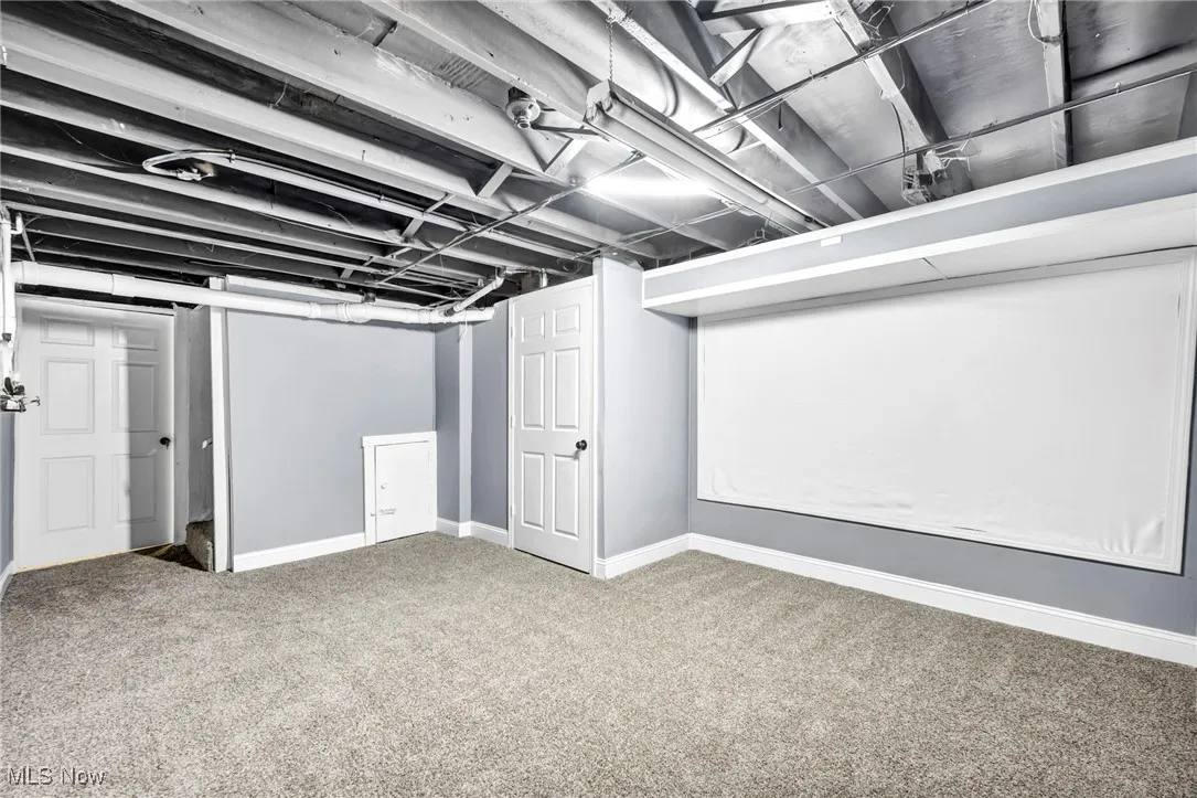 Finished basement with carpet floors and baseboards