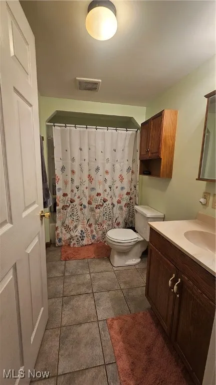 Bathroom with vanity and tile patterned floors