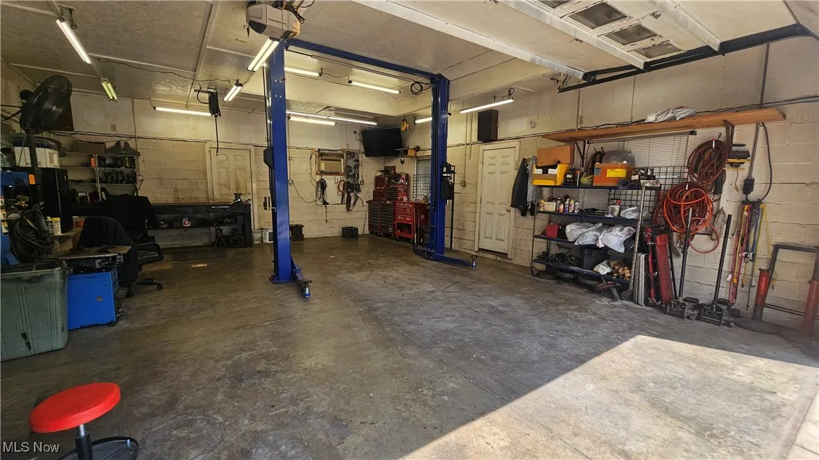 Garage with a workshop area and a garage door opener