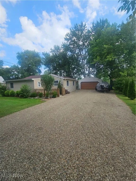 View of front facade featuring an outbuilding and a garage