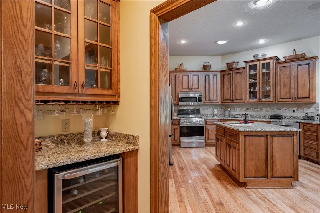 Between the kitchen and dining room is a butlers pantry featuring a wine cooler, granite counters and plenty of glassware storage.