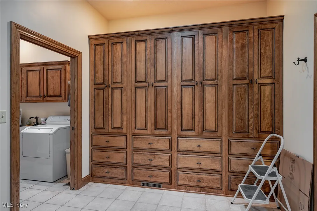 Master closet also has plenty of built-in cabinets and drawers.