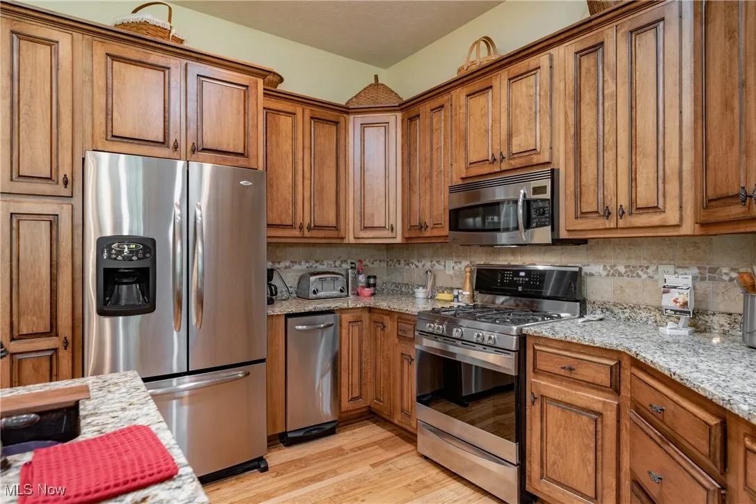 The Gourmet Kitchen features maple cabinets, Stainless Steel appliances, under cabinet lighting and granite counter tops.