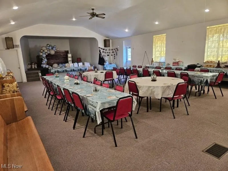 Dining space with carpet, lofted ceiling, ceiling fan, and recessed lighting