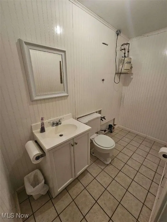 Bathroom featuring tile patterned flooring, vanity, and a shower