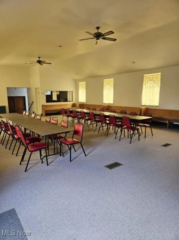 Dining room with carpet flooring and ceiling fan