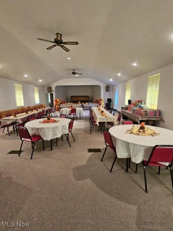 Dining space with lofted ceiling, carpet floors, recessed lighting, and ceiling fan
