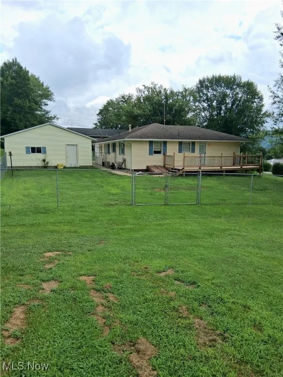 View of yard with a wooden deck