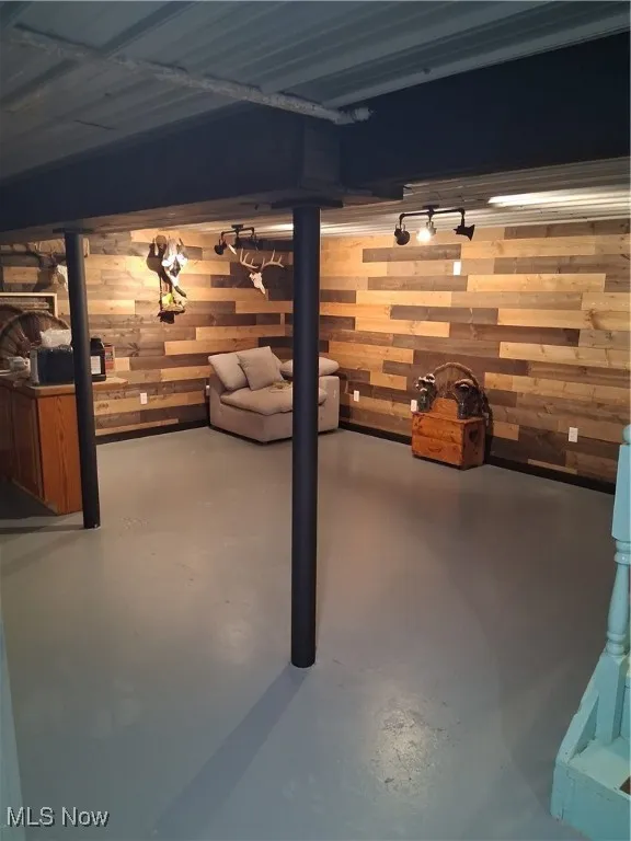 Finished below grade area featuring wood walls