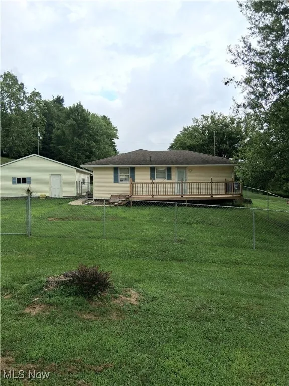 Back of house featuring a wooden deck
