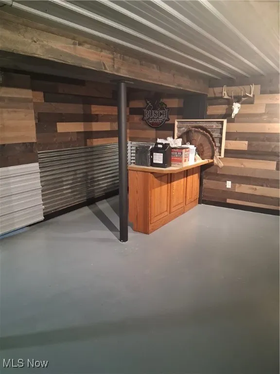 Below grade area featuring wood walls