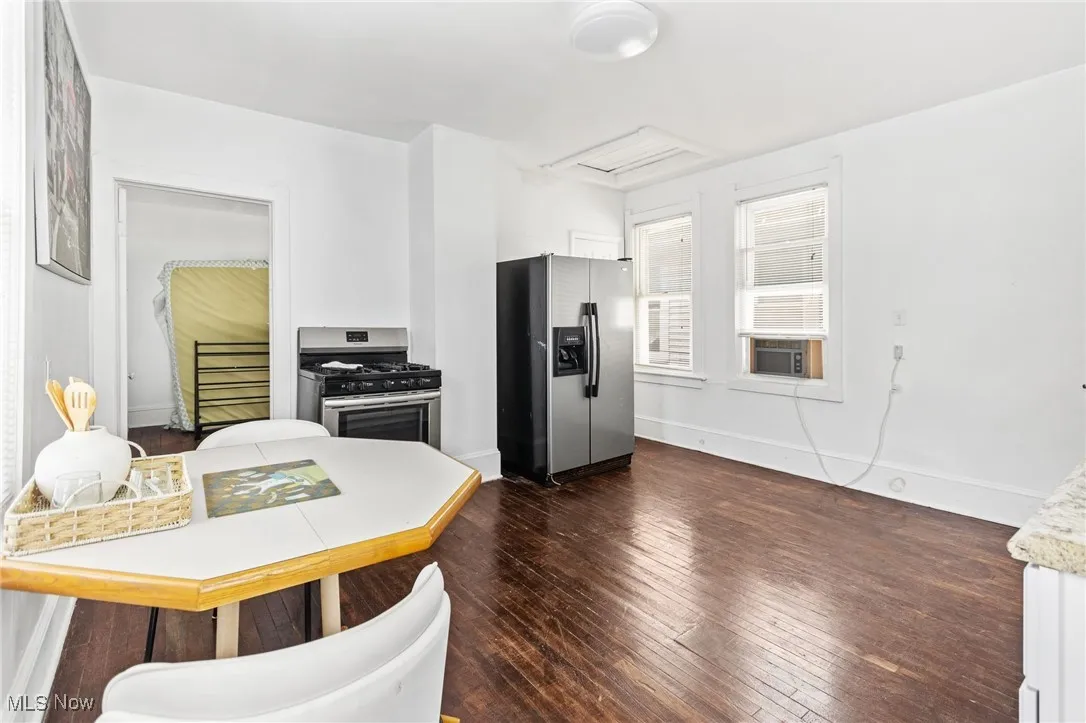 Kitchen featuring appliances with stainless steel finishes, dark wood finished floors, and light countertops