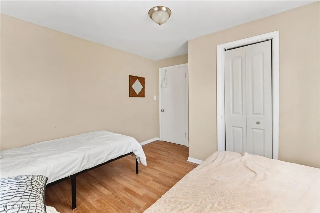 Bedroom featuring light wood-type flooring and a closet