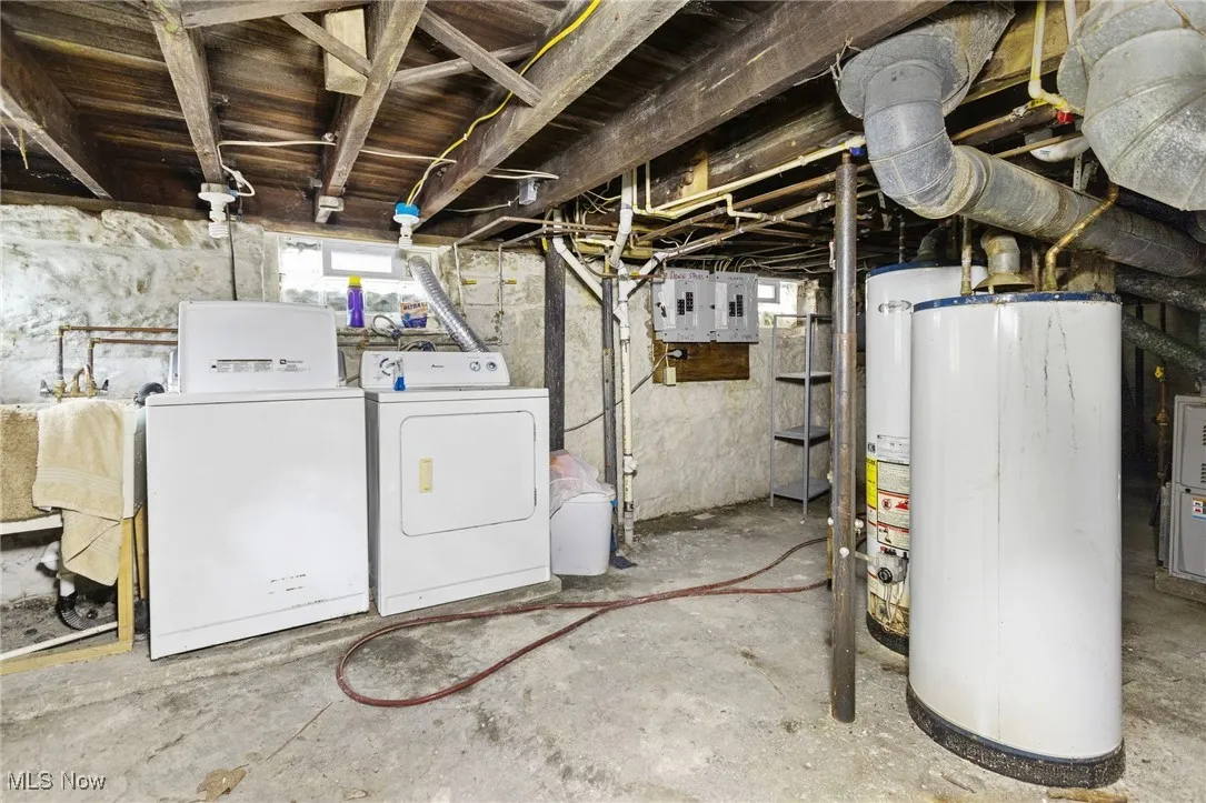 Below grade area featuring washer and clothes dryer and water heater