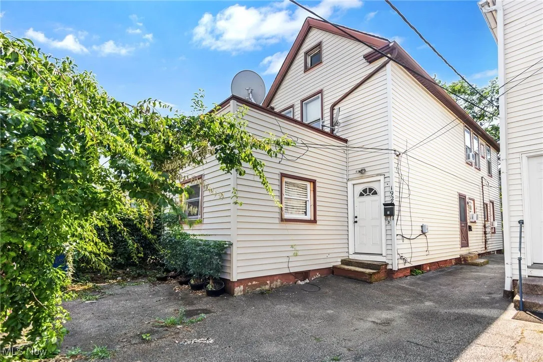 Back of house with crawl space