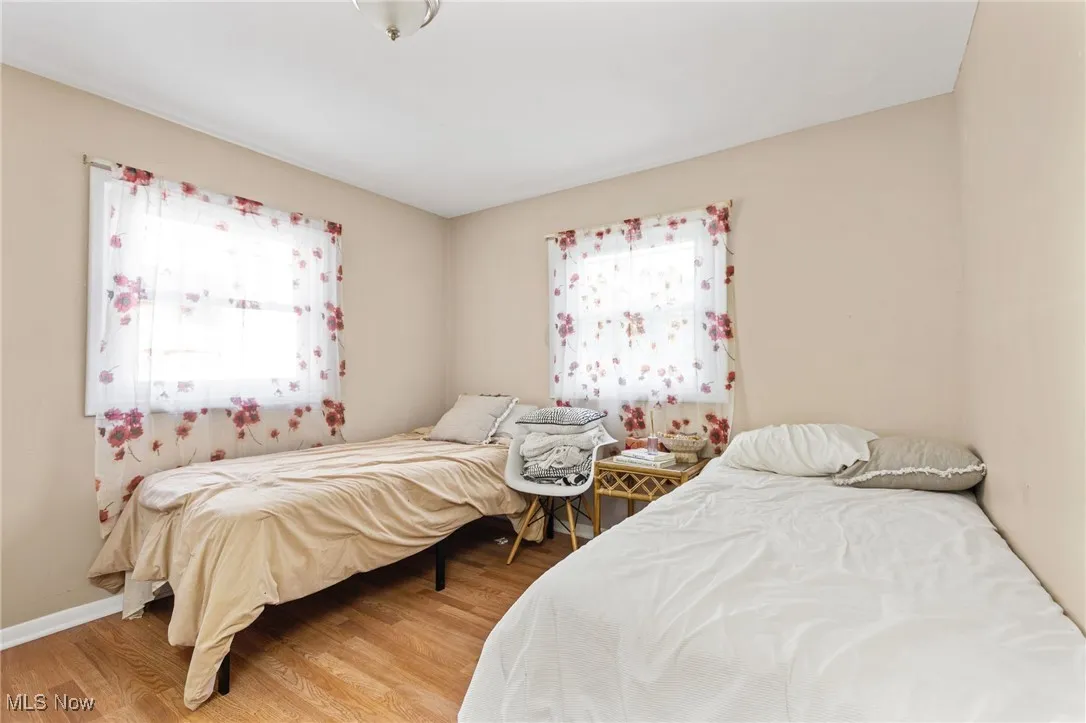 Bedroom featuring light wood finished floors and baseboards