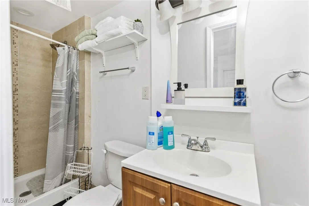 Bathroom featuring a stall shower and vanity