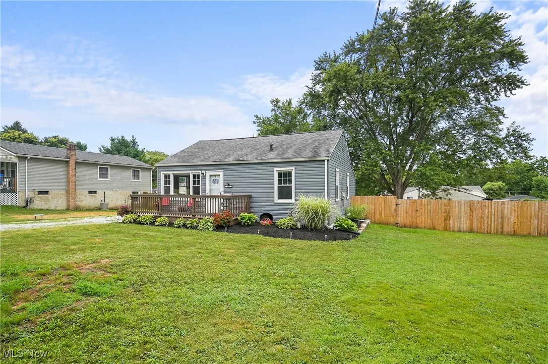 Rear view of house with a wooden deck