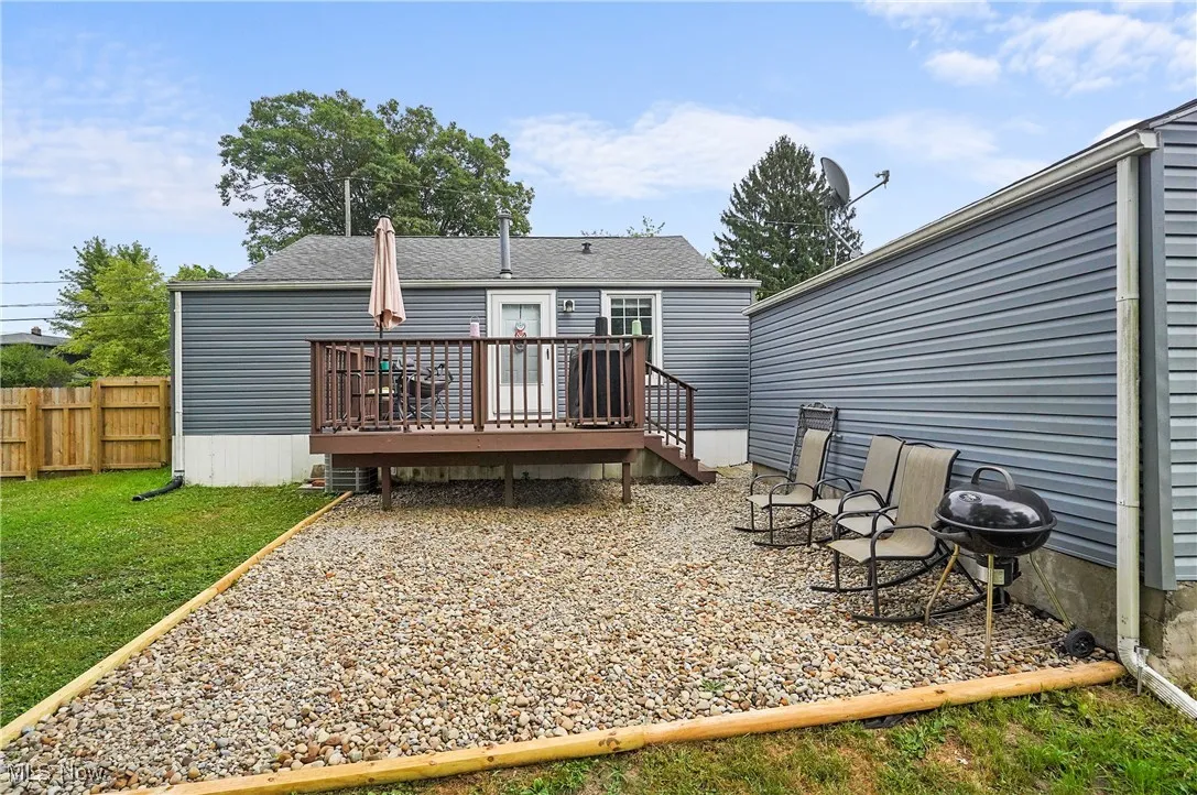 Rear view of property featuring a wooden deck