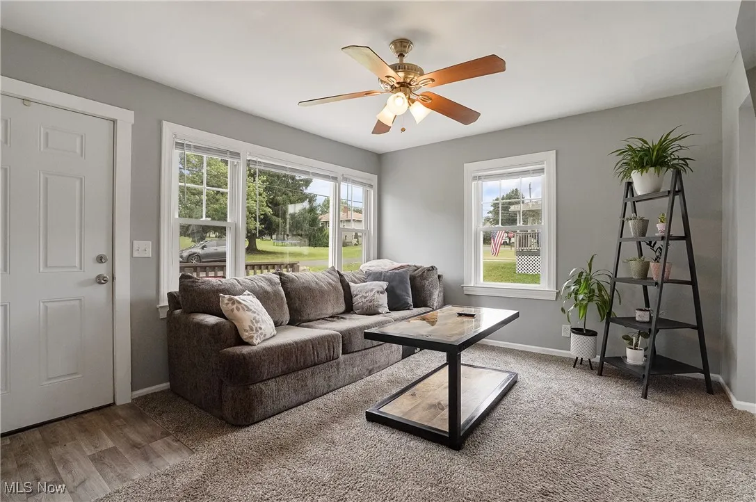 Living area with plenty of natural light and ceiling fan