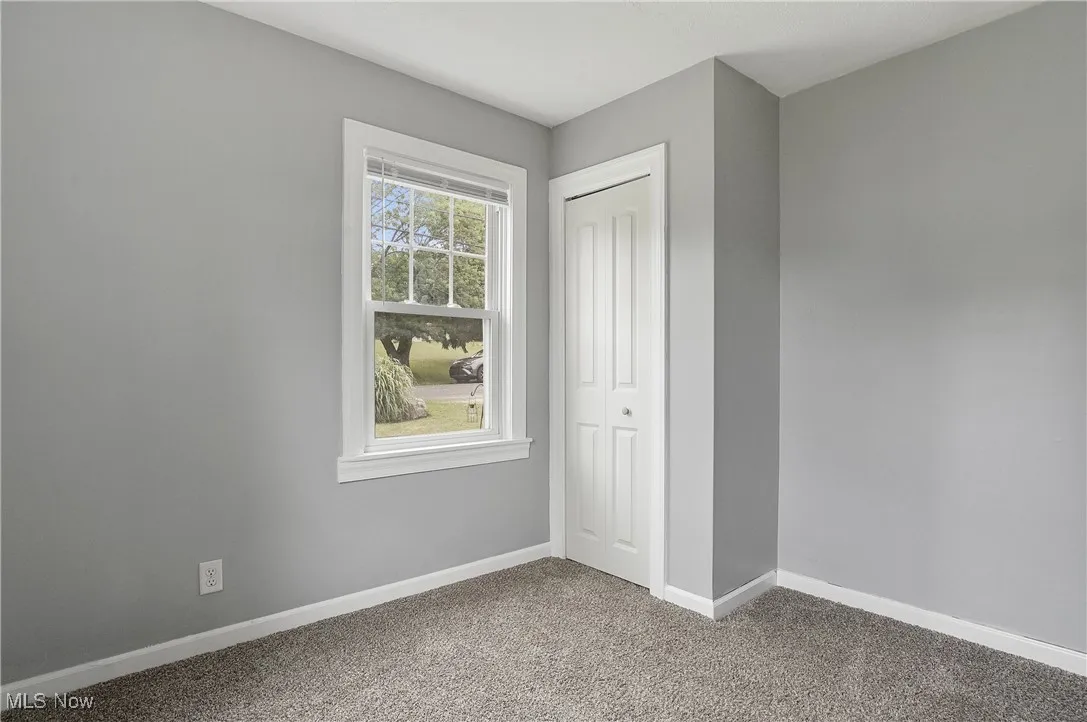 Unfurnished bedroom featuring carpet and a closet
