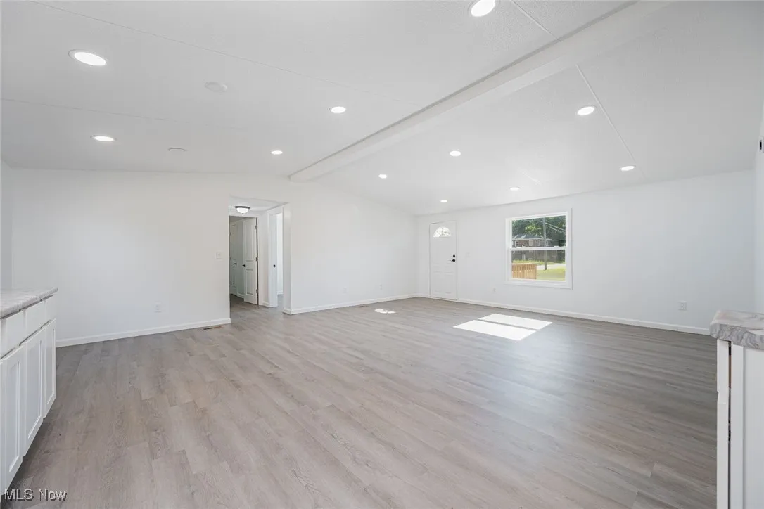 Unfurnished living room featuring light wood-type flooring and recessed lighting