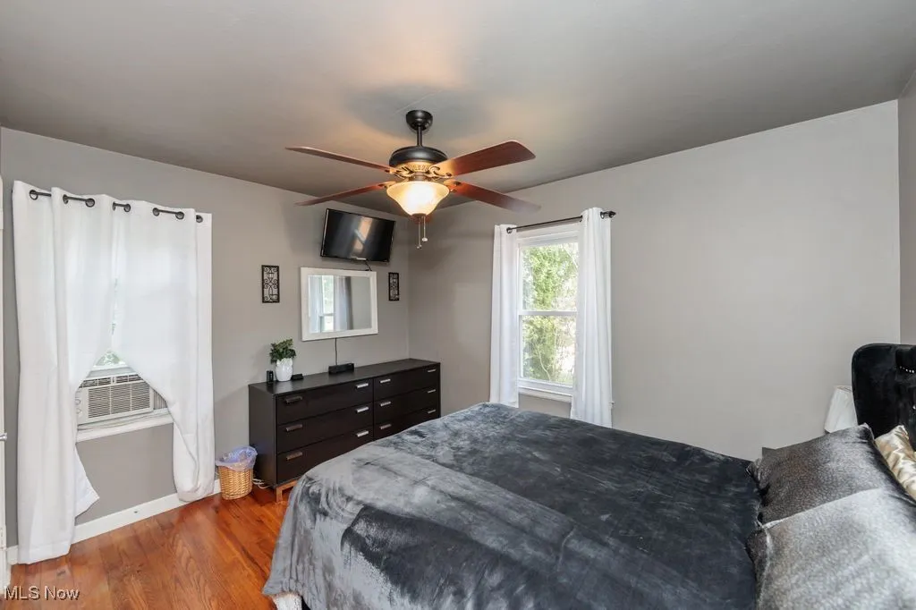 Bedroom with wood finished floors and ceiling fan