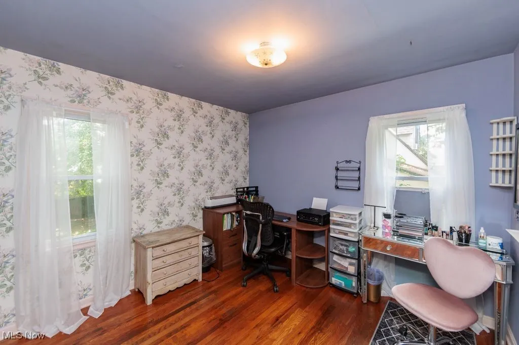 Office featuring wood finished floors, plenty of natural light, and wallpapered walls