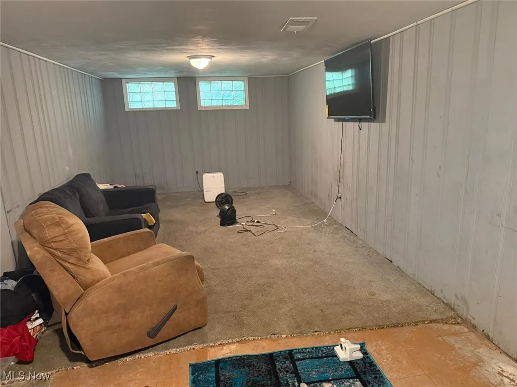 Living area featuring wooden walls