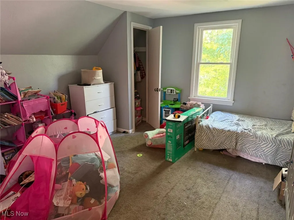 Carpeted bedroom with vaulted ceiling