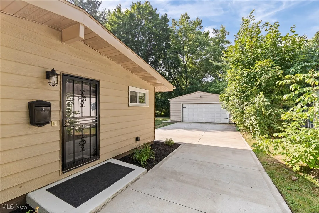Entrance to property featuring a detached garage