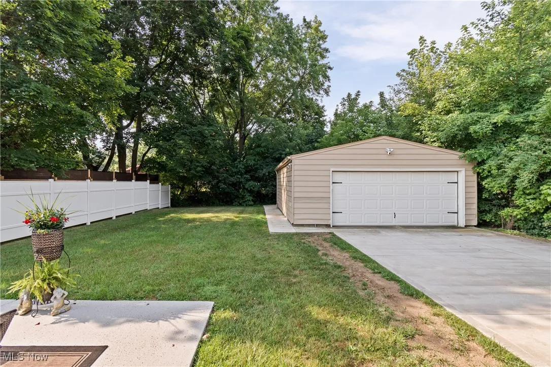 View of yard with an outdoor structure and a garage