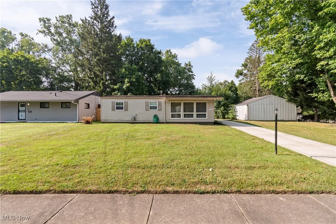 View of front of house with a front yard and driveway