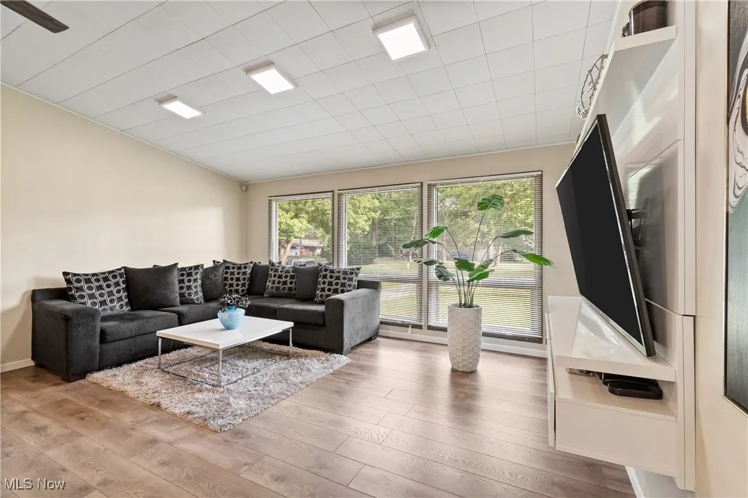 Living area featuring wood finished floors and vaulted ceiling