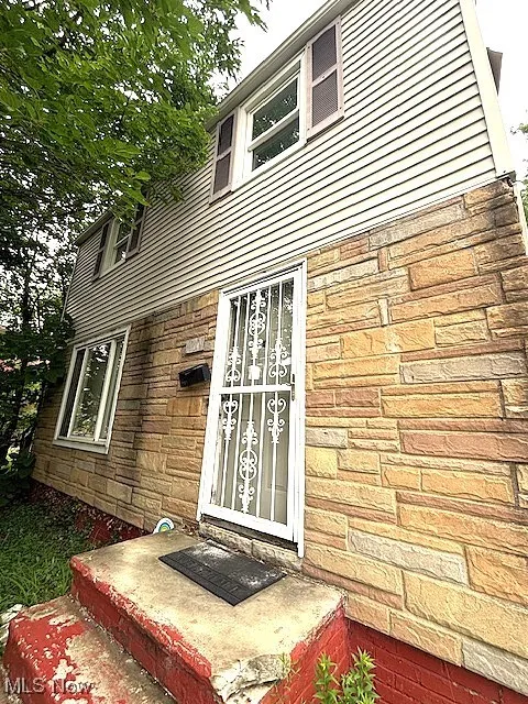 Property entrance with stone siding