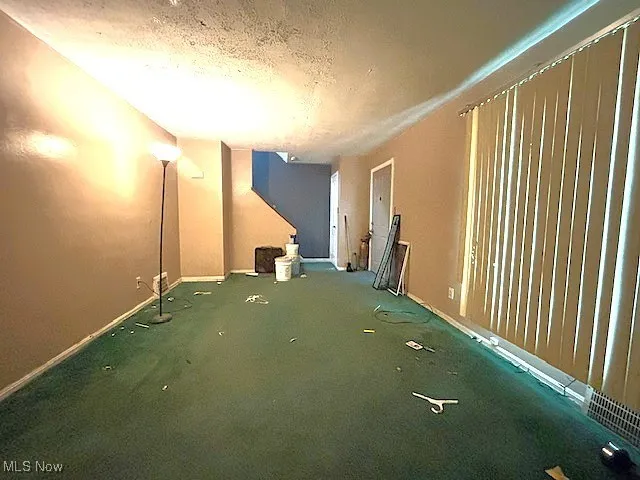 Spare room featuring baseboards and a textured​​‌​​​​‌​​‌‌​‌‌​​​‌‌​‌​‌​‌​​​‌​​ ceiling