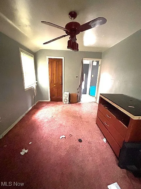 Unfurnished bedroom with carpet floors and ceiling fan