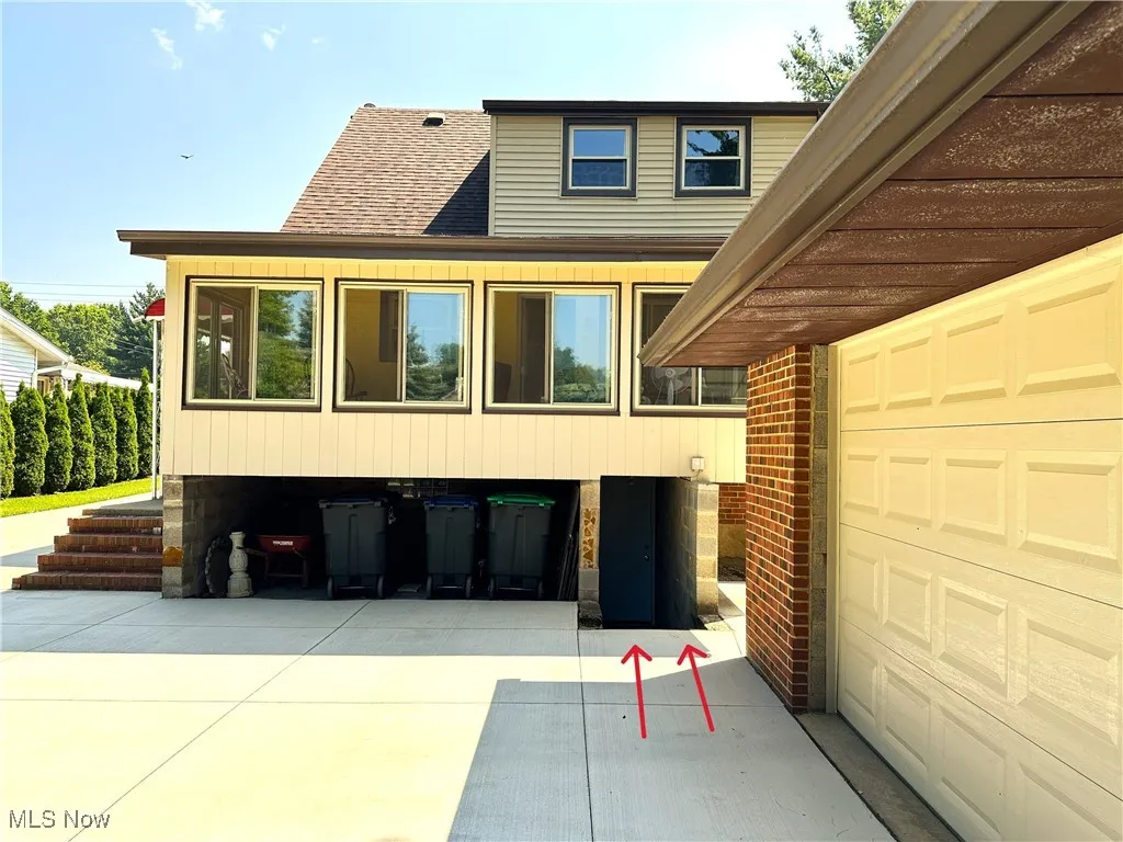 Arrows point to door to basement located very close to the garage