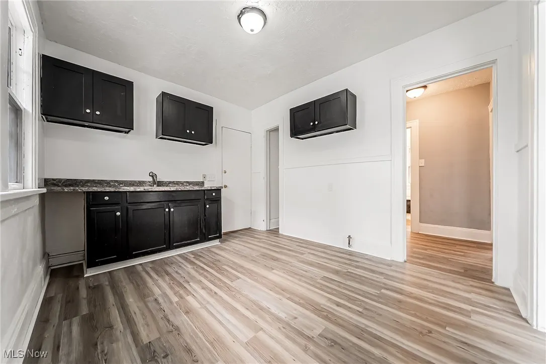 Bar with light wood finished floors and baseboards