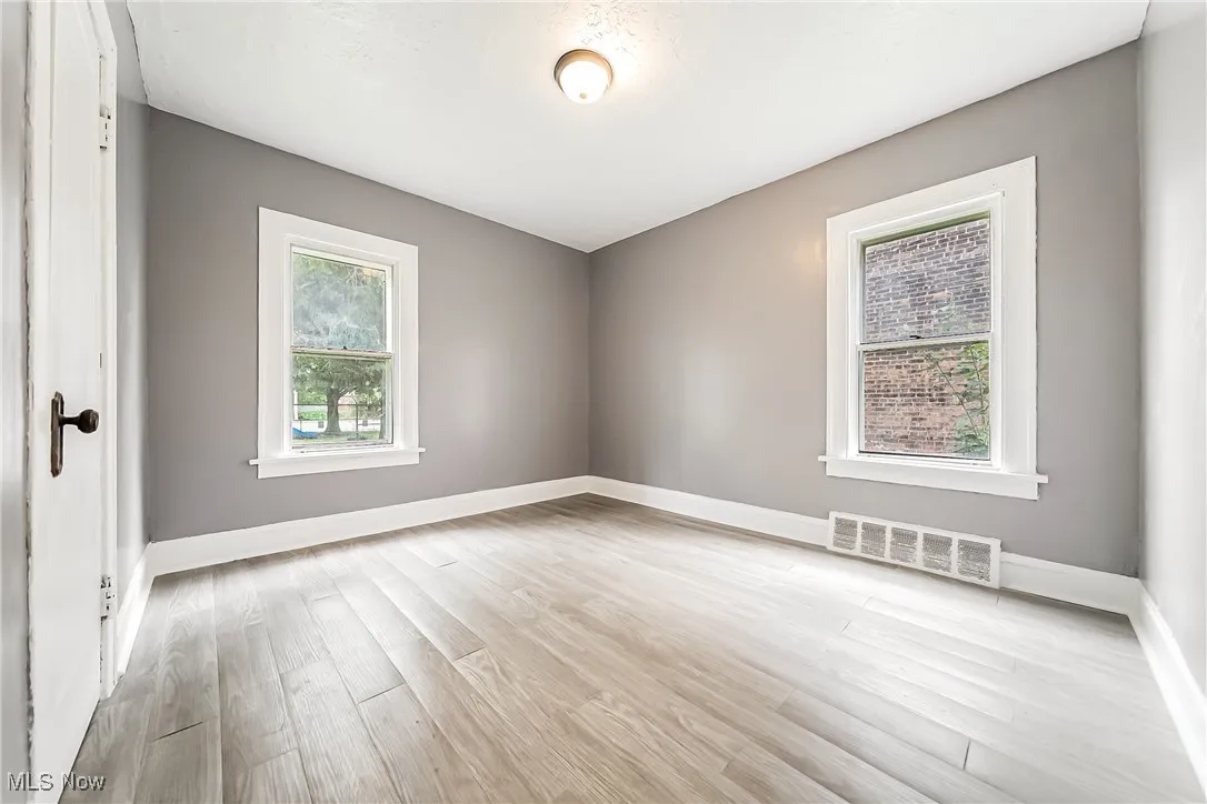 Spare room with light wood finished floors and baseboards