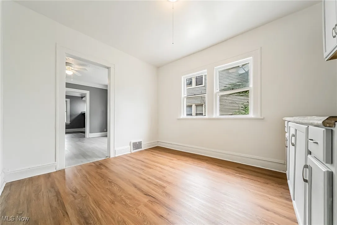 Unfurnished dining area with light wood finished floors and ceiling fan