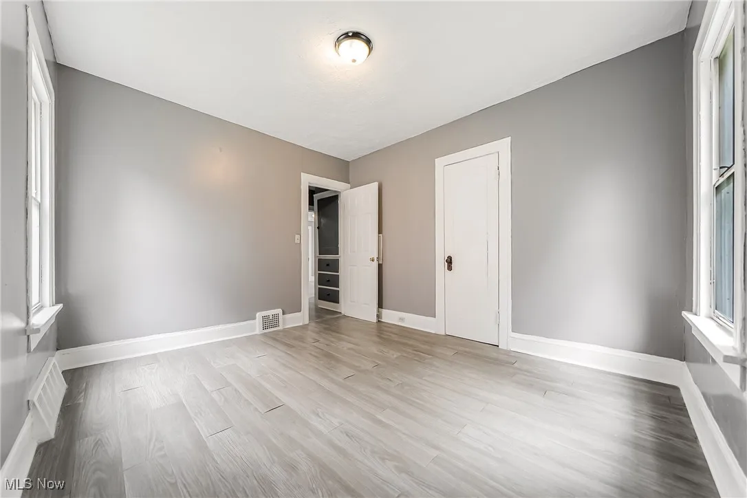 Empty room featuring baseboards and light wood-style floors