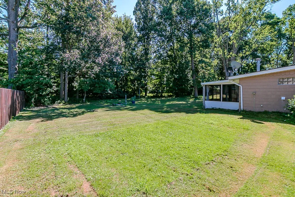 View of yard featuring a sunroom