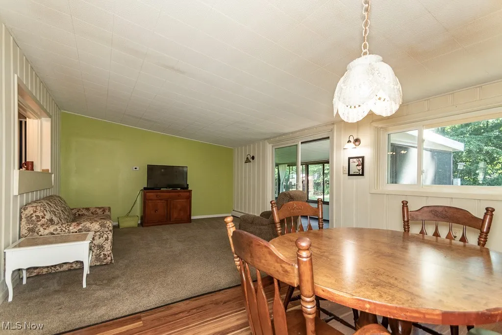 Dining room with healthy amount of natural light and wood finished floors