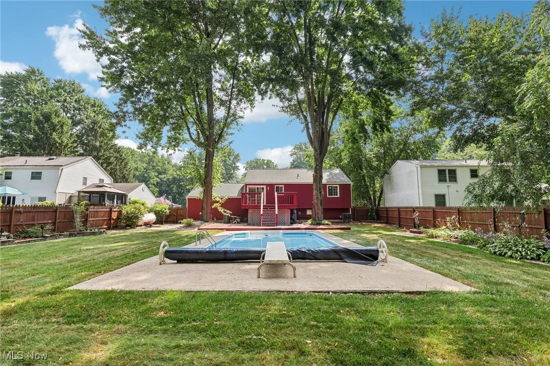 Beautifully landscaped fenced in backyard with 2 level deck and heated in-ground pool for relaxing and entertaining!